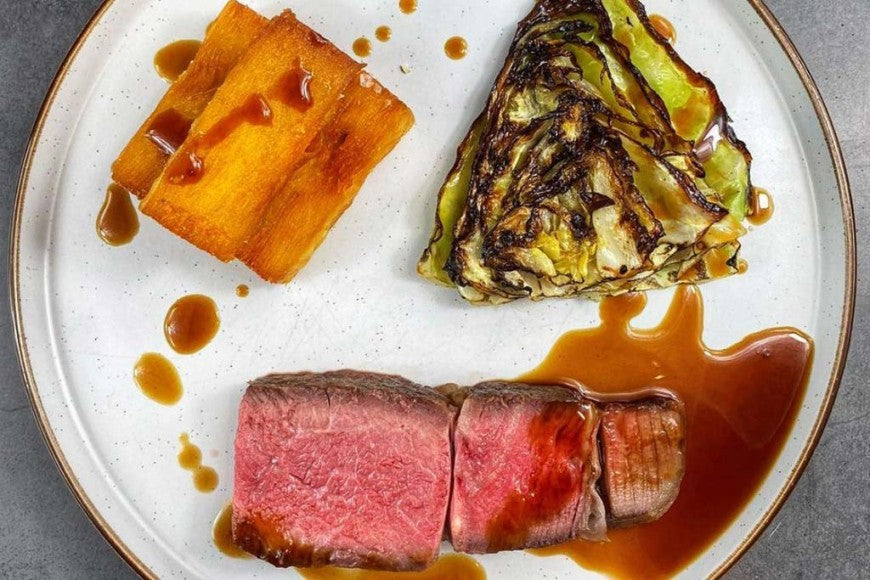 Rib of Beef with Potato Terrine Chips & Charred Hispi Cabbage