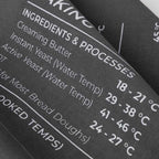 Baking ingredient and temperature chart with text on a grey tea towel