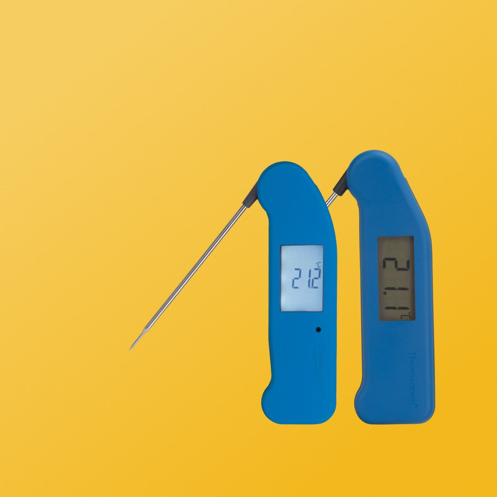 Orange thermapen classic and blue thermapen one on a yellow gradient background 