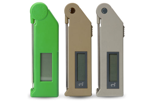 Three generations of old fashioned Thermapen food thermometers, one green, one brown and one grey