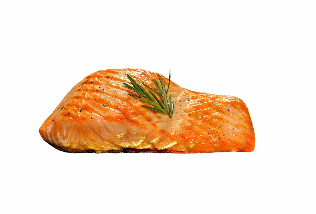 A single, perfectly cooked salmon fillet with a beautiful golden-orange hue, showing a lightly browned, crispy exterior and subtle flaking. It's seasoned with black pepper and garnished with a small sprig of fresh rosemary on top, isolated on a bright white background.