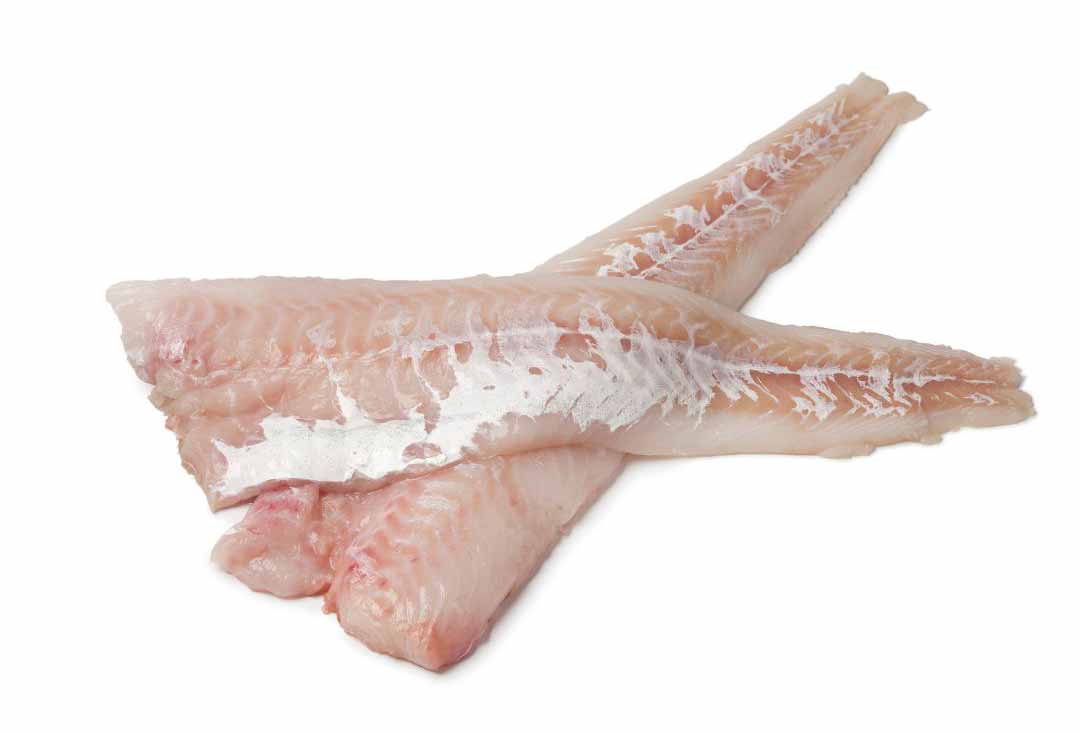 Two fresh, raw haddock fillets, pale pinkish-white in color with visible flaking and some silver skin remnants, laid across each other on a clean white background, ready for cooking.