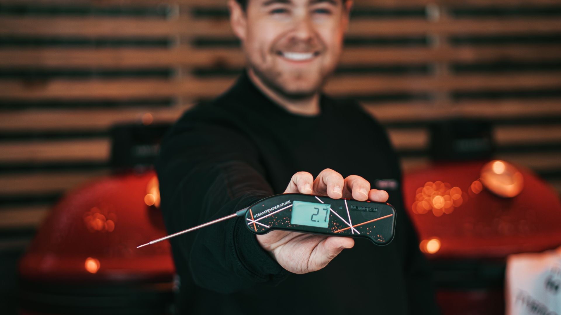 Person holding a digital thermometer with a blurred background