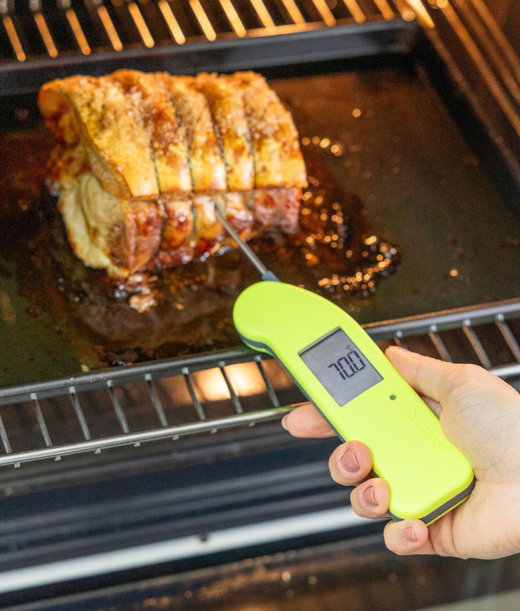 hi-vis Thermapen probing a pork joint in the oven