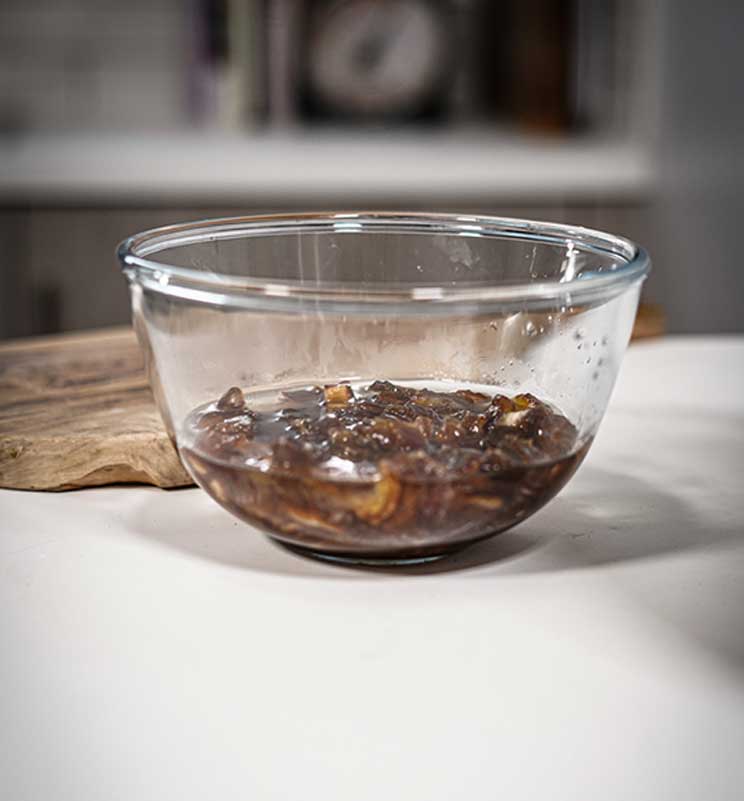 Glass bowl on the kitchen island with dates soaking in the water