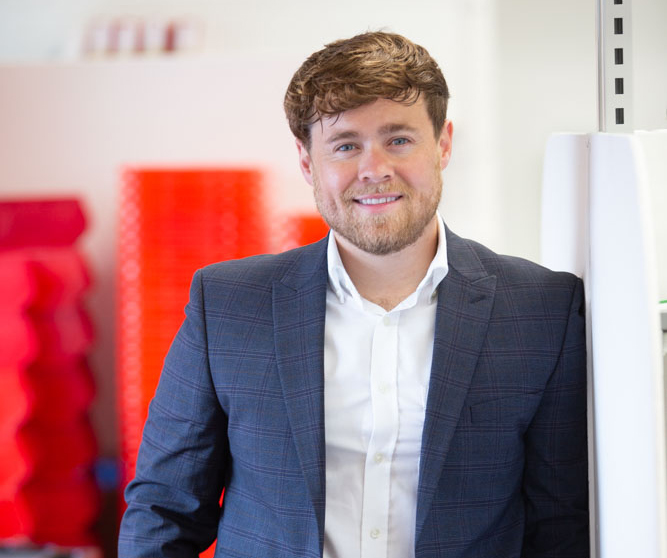 The Managing Director of ETI smiling in a suit 