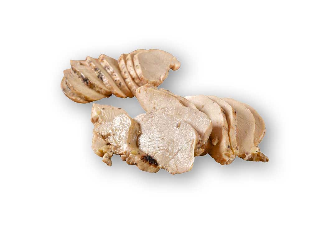 A collection of thinly sliced, cooked chicken breast pieces are arranged in two overlapping piles on a plain white background, showing the lean juicy meat with a slight sear on some edges.