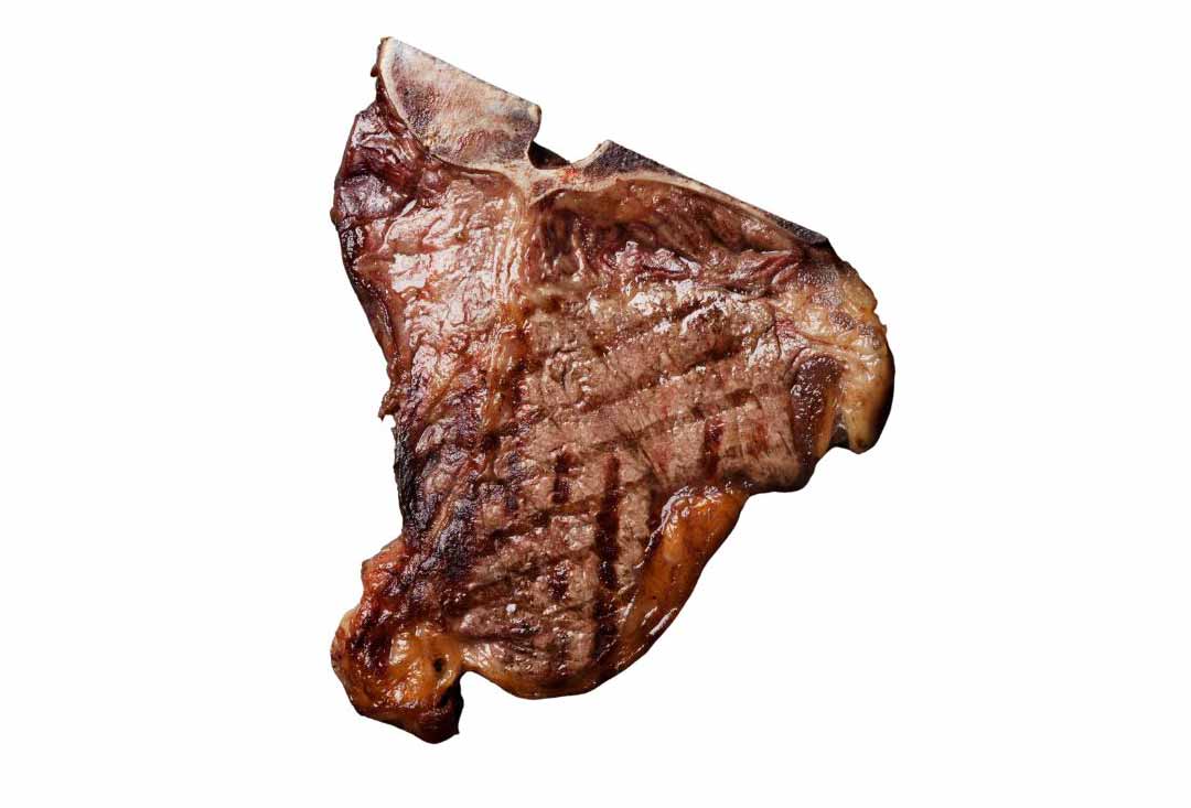 A perfectly cooked T-bone steak, unsliced and resting, showcasing distinct char marks from grilling and a rich brown crust. The characteristic T-shaped bone is visible at the top, and the steak is isolated on a bright white background.