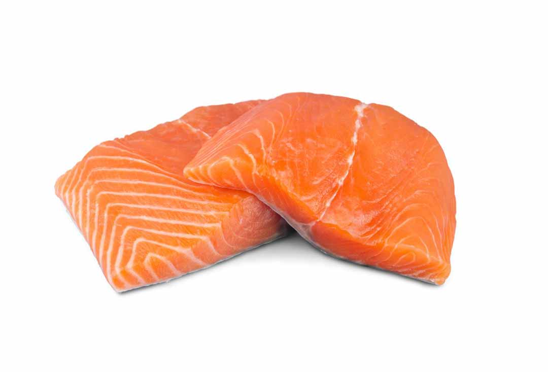 Two vibrant orange, fresh raw salmon fillets, one slightly overlapping the other, showcasing their distinct white fat lines and smooth texture, isolated on a pure white background.