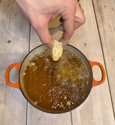 Cod being dipped into the oil