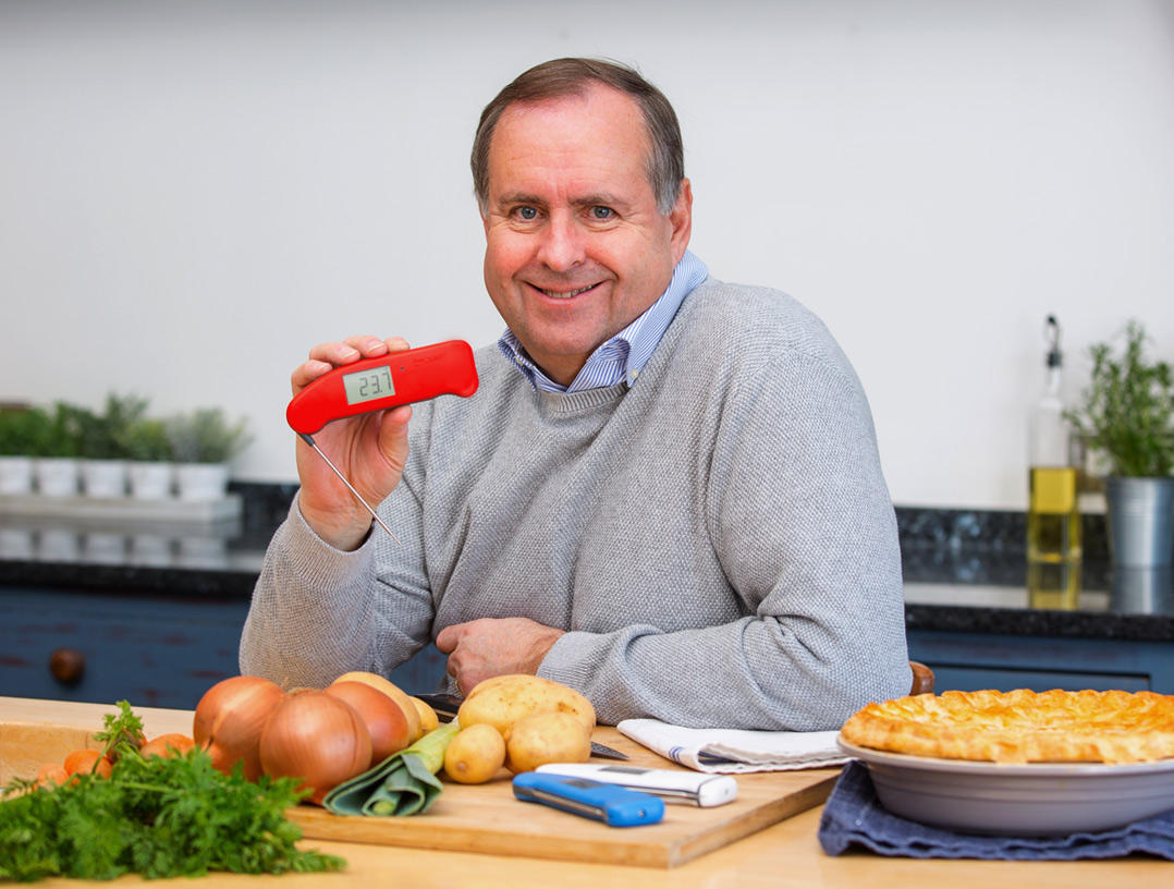 ETI's founder sat at his kitchen table presenting a red Thermapen, food thermometer