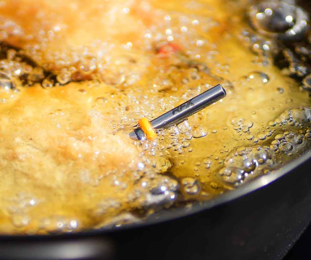 RFX Meat probe inserted in breadcrumbed chicken cooking in oil that's bubbling away