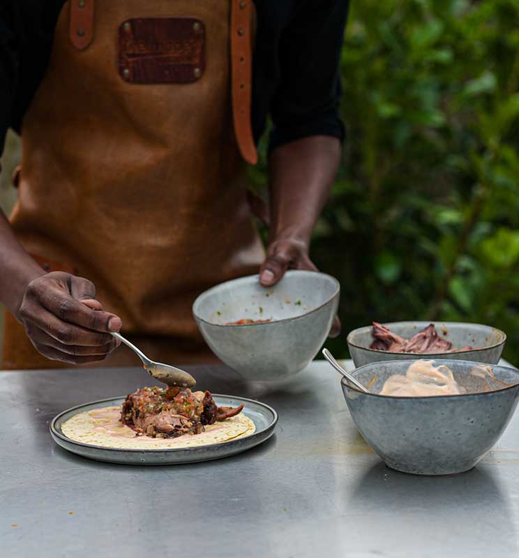Chef putting together a pulled pork taco