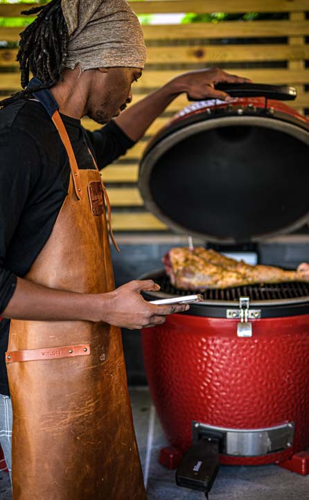 Chef checking the cook of the leg of lamb on the bbq