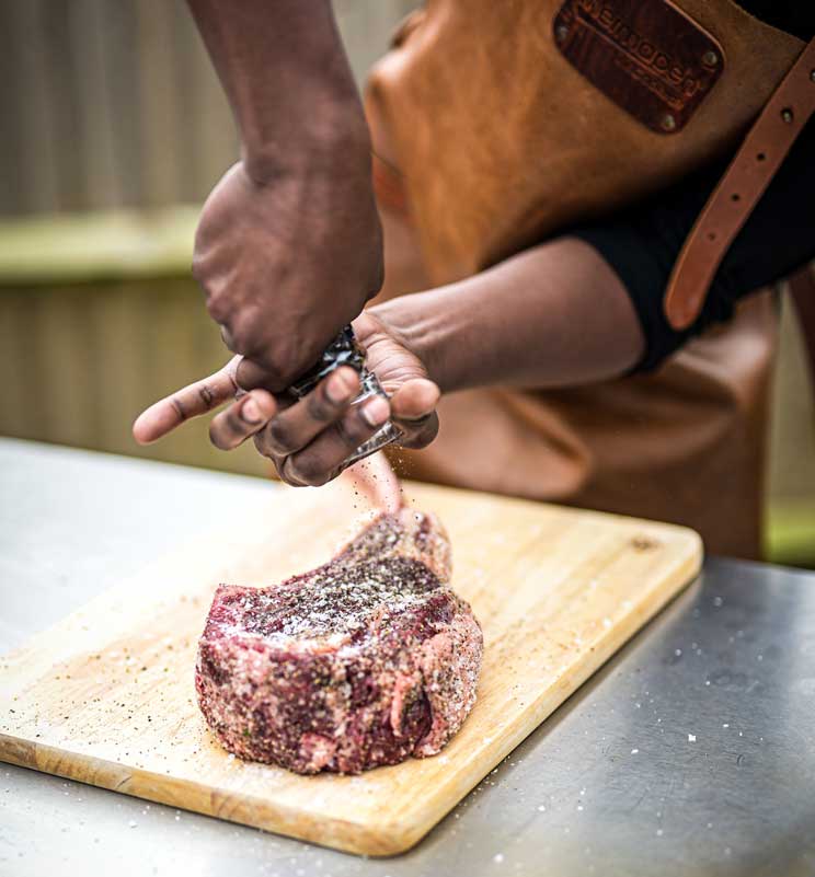 chef seasoning tomahawk steak