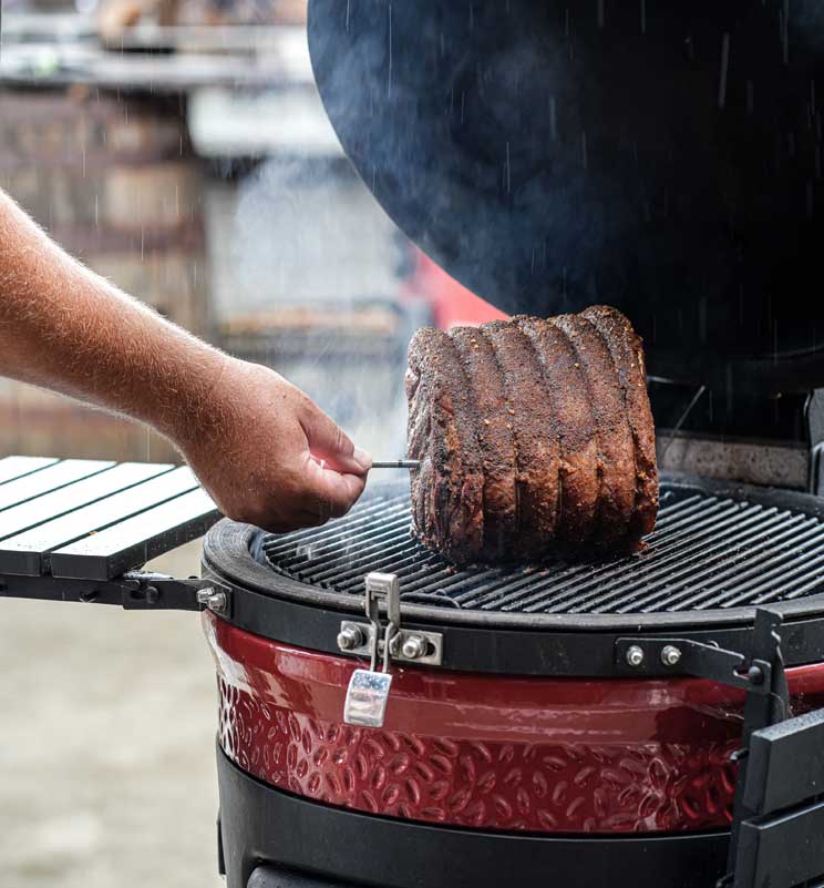 rfx probe being place into beef joint on a kamado joe bbq