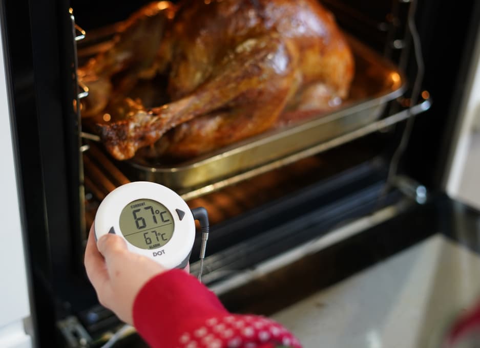 This image features several Thermapen brand cooking thermometers and accessories arranged on a dark, festive background with silver tinsel.